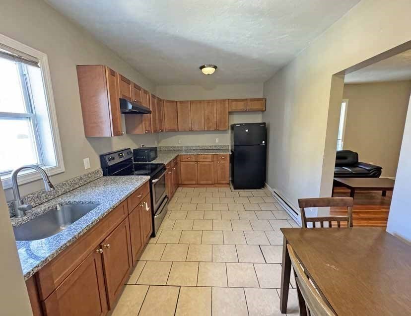 190 Washington Street Lynn, MA 01902 - Photo 10 of 19 a kitchen with stainless steel appliances granite countertop a sink stove and cabinets