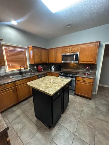 a kitchen with a stove and a sink