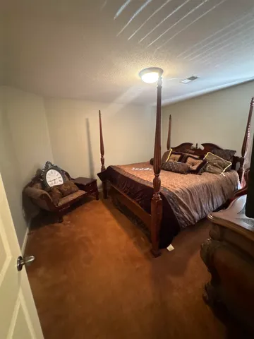 a bedroom with a bed and a night stand