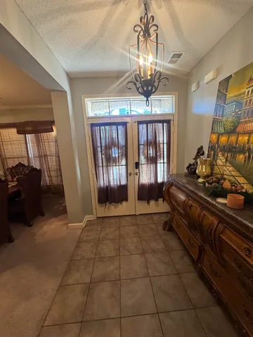 a lobby with furniture and a chandelier
