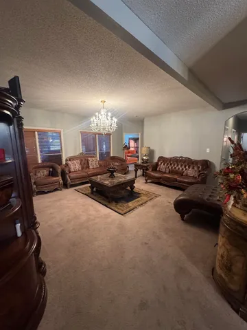 a gym room with furniture and a flat screen tv