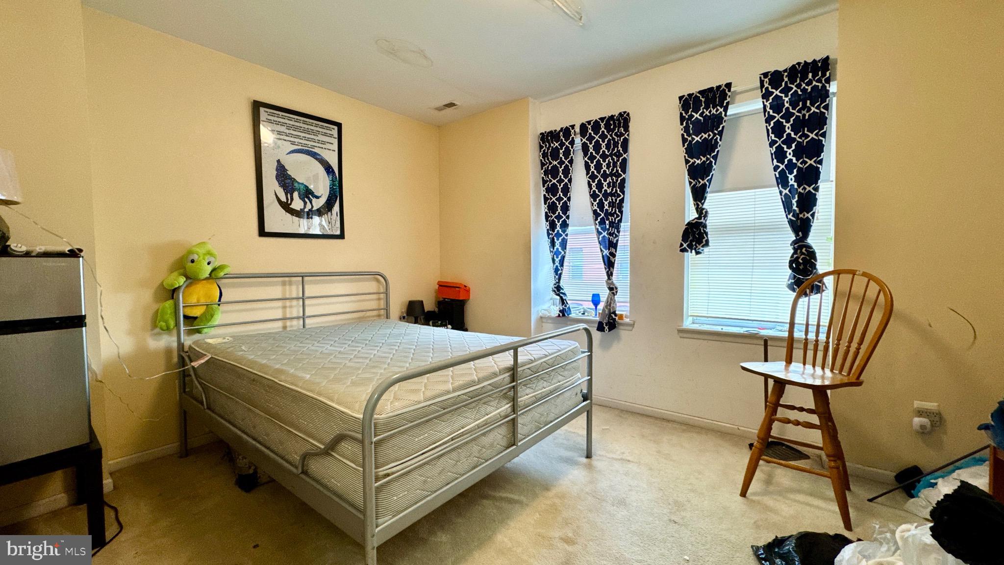 1934 North 23rd Street Philadelphia, PA 19121 - Photo 11 of 17 a bedroom that has a bed and a chair in it