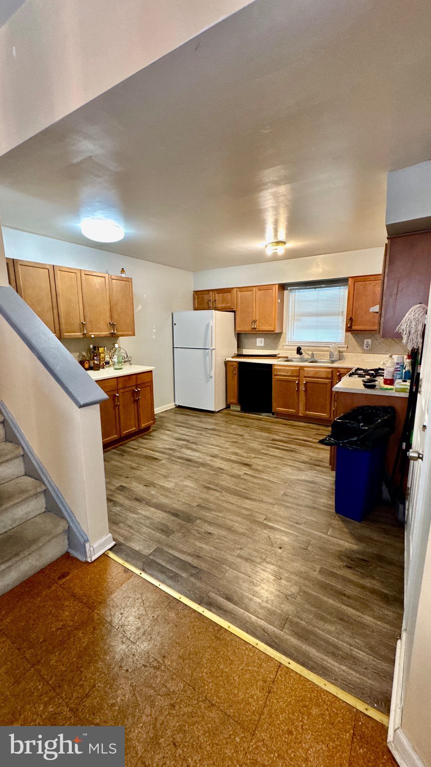 1934 North 23rd Street Philadelphia, PA 19121 - Photo 5 of 17 a kitchen with stainless steel appliances wooden floor and a view of living room