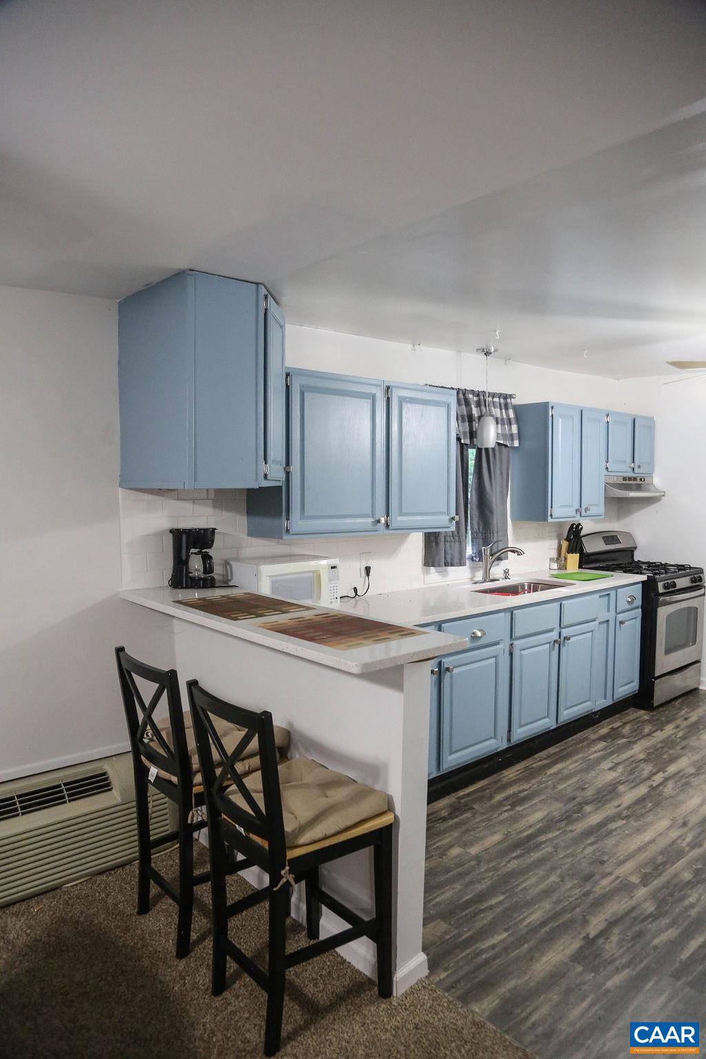 6473 Plank Road Afton, VA 22920 - Photo 31 of 66 a kitchen with stainless steel appliances granite countertop a table chairs sink refrigerator and cabinets