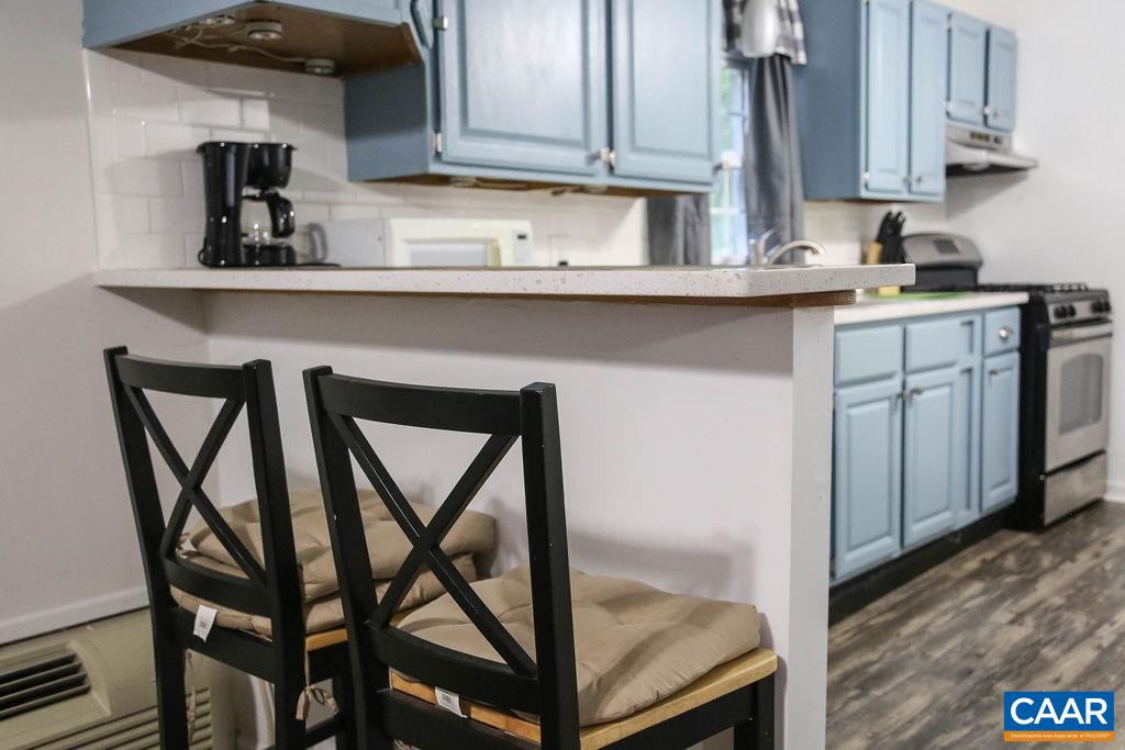 6473 Plank Road Afton, VA 22920 - Photo 50 of 66 a kitchen with stainless steel appliances granite countertop a table chairs sink and cabinets