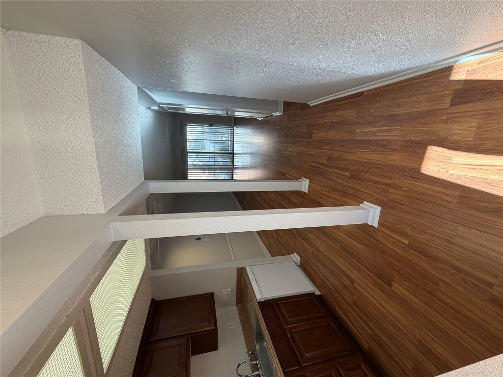 1725 Toomey Road, Unit 310 Austin, TX 78704 - Photo 5 of 11 a view of a hallway with wooden floor