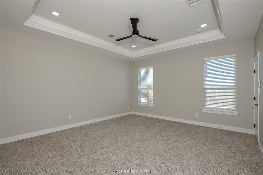 2908 GOLDBERG Drive Bryan, TX 77808 - Photo 30 of 44 Bedroom features: window treatments, base molding, ceiling fan with a light kit plus remote control and carpeting.