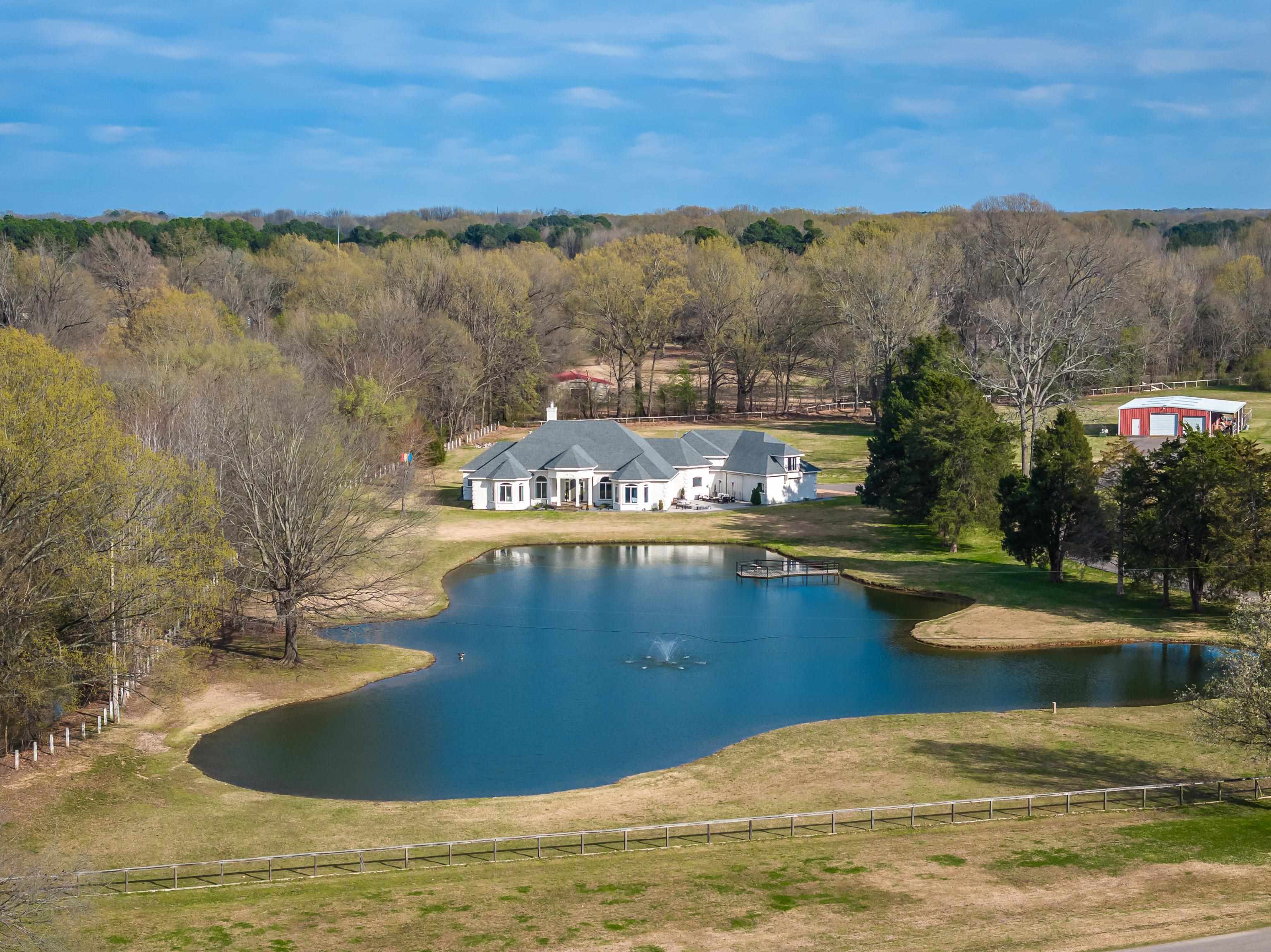 10471 Collierville Road Collierville, TN 38017 - Photo 1 of 40 Drone / aerial view with a wooded view and a water view