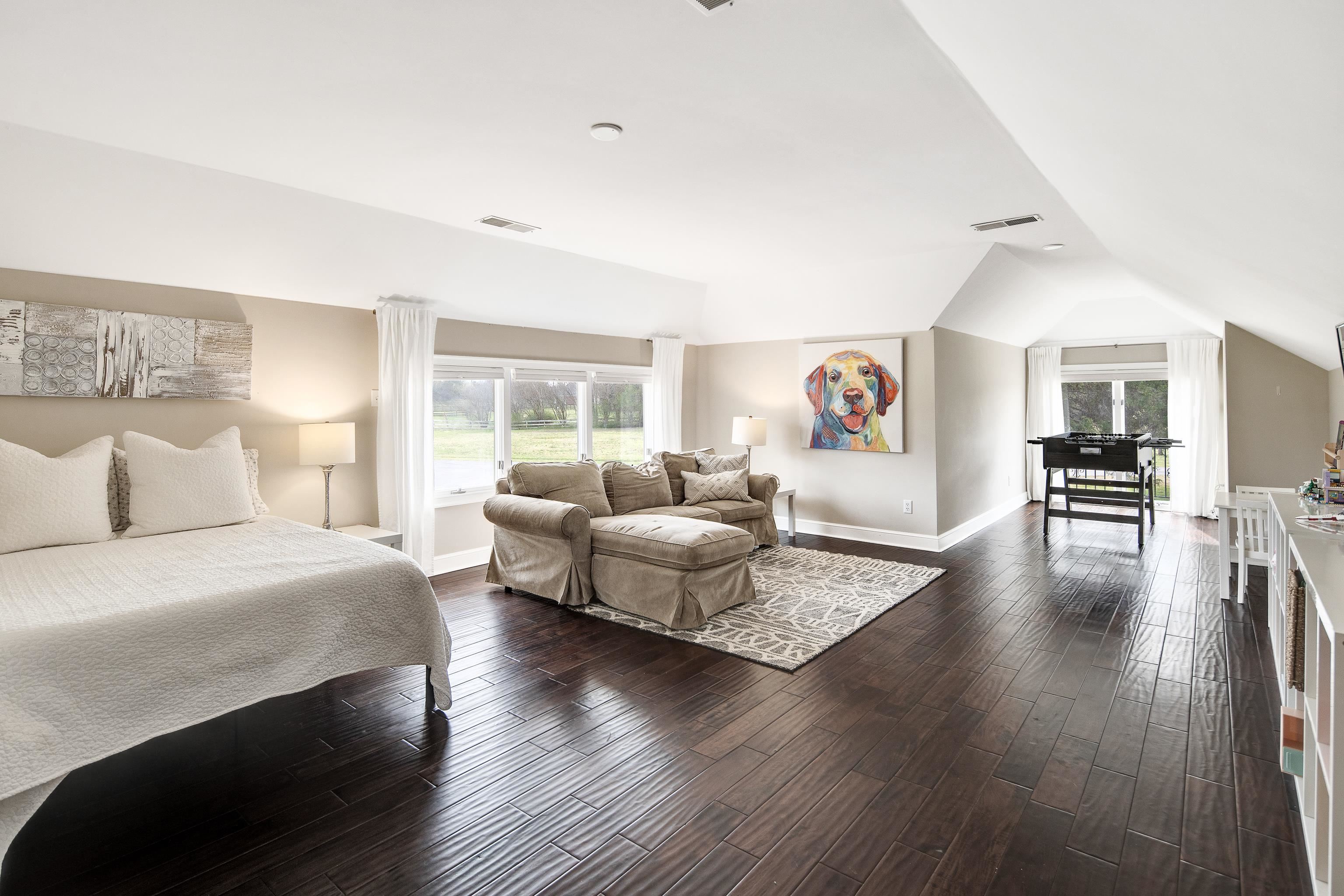 10471 Collierville Road Collierville, TN 38017 - Photo 21 of 40 Bedroom with vaulted ceiling, multiple windows, visible vents, and dark wood-style flooring
