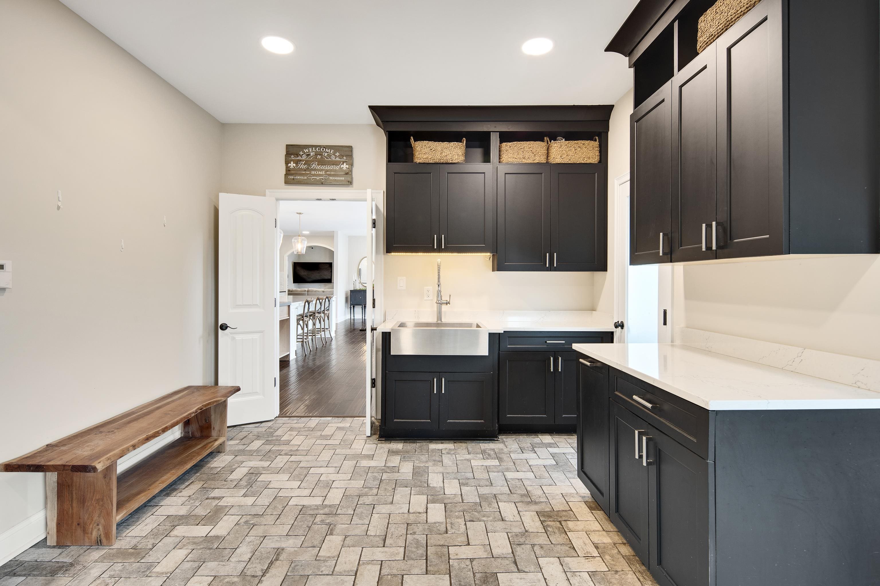 10471 Collierville Road Collierville, TN 38017 - Photo 23 of 40 Kitchen featuring open shelves, recessed lighting, brick floor, a sink, and light countertops