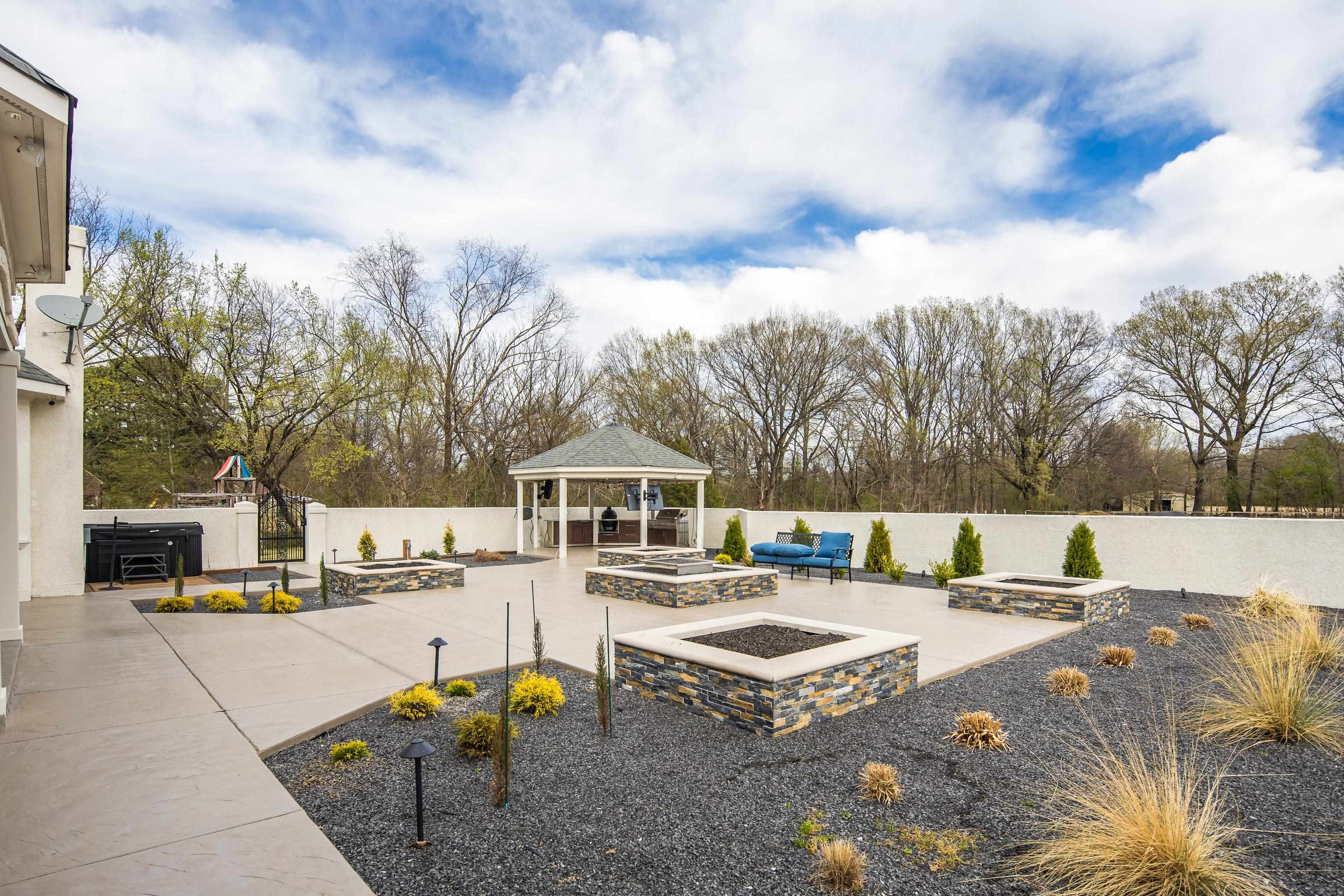 10471 Collierville Road Collierville, TN 38017 - Photo 28 of 40 View of patio featuring a gazebo, a fenced backyard, a hot tub, and an outdoor fire pit