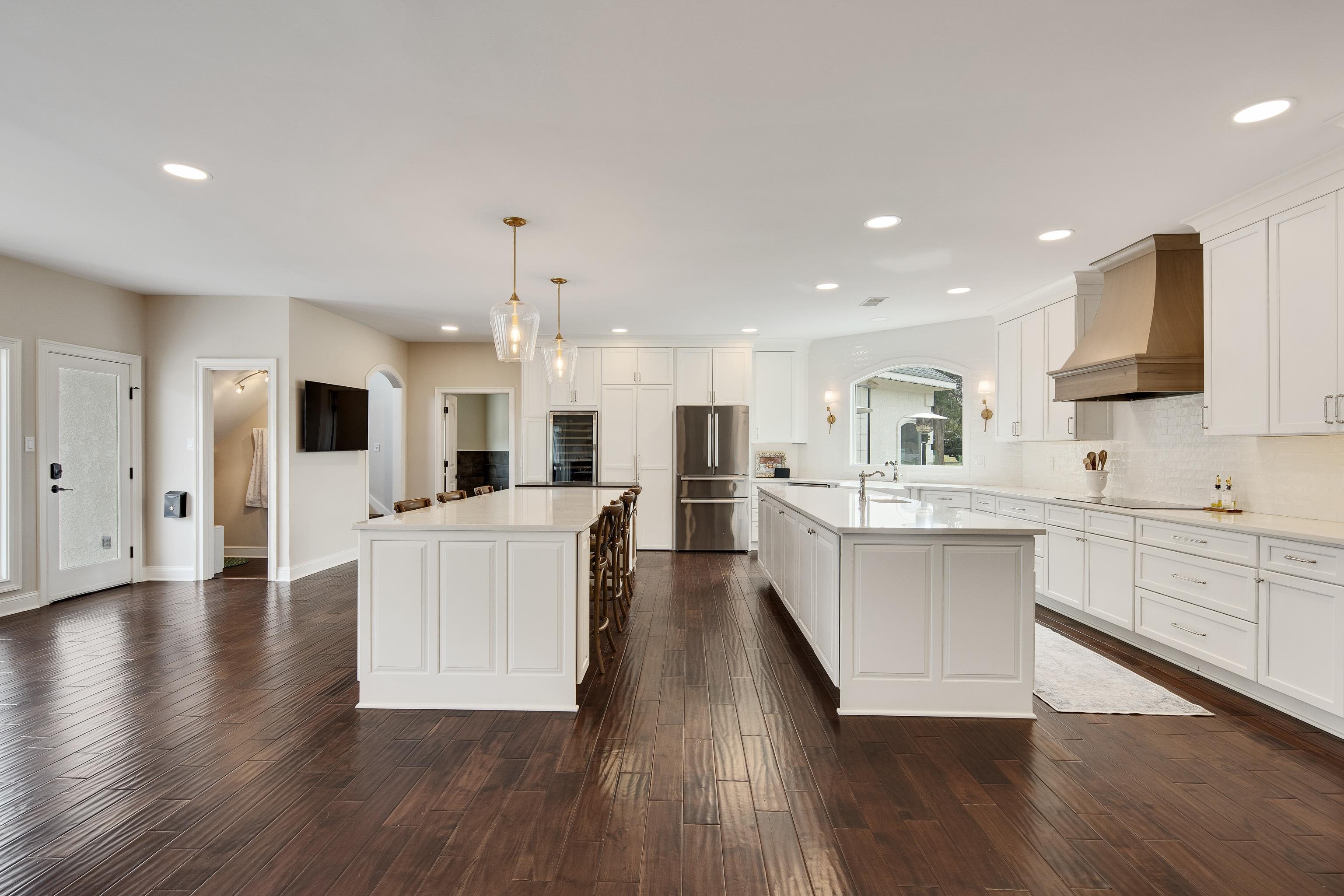 10471 Collierville Road Collierville, TN 38017 - Photo 7 of 40 Kitchen featuring custom exhaust hood, an island with sink, light countertops, and freestanding refrigerator