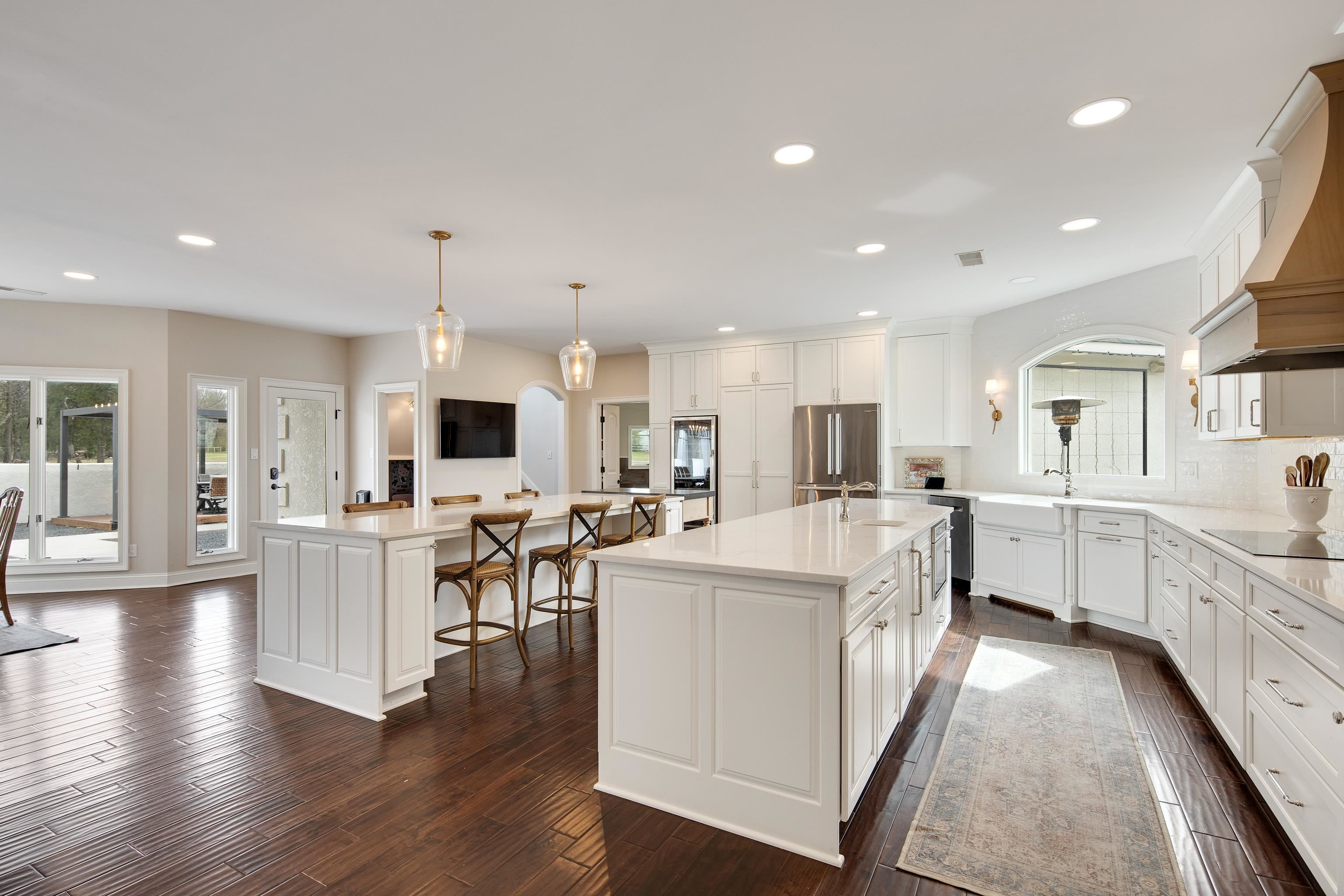10471 Collierville Road Collierville, TN 38017 - Photo 8 of 40 Kitchen with a kitchen island with sink, freestanding refrigerator, custom exhaust hood, black electric cooktop, and a sink