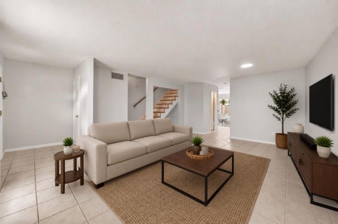 6404 Burgoyne Road, Unit 159 Houston, TX 77057 - Photo 7 of 38 Spacious living room with neutral tones and tiled floor, leading to an open staircase and dining area - virtually staged