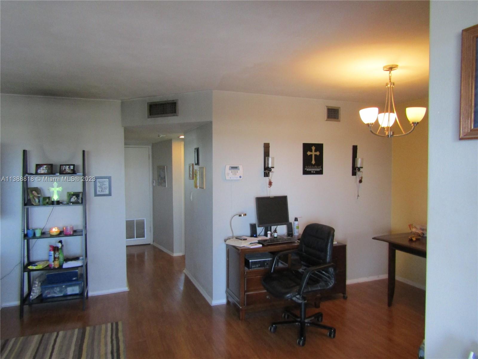 651 Pine Drive, Unit 309 Pompano Beach, FL 33060 - Photo 11 of 38 a view of a workspace with furniture and wooden floor