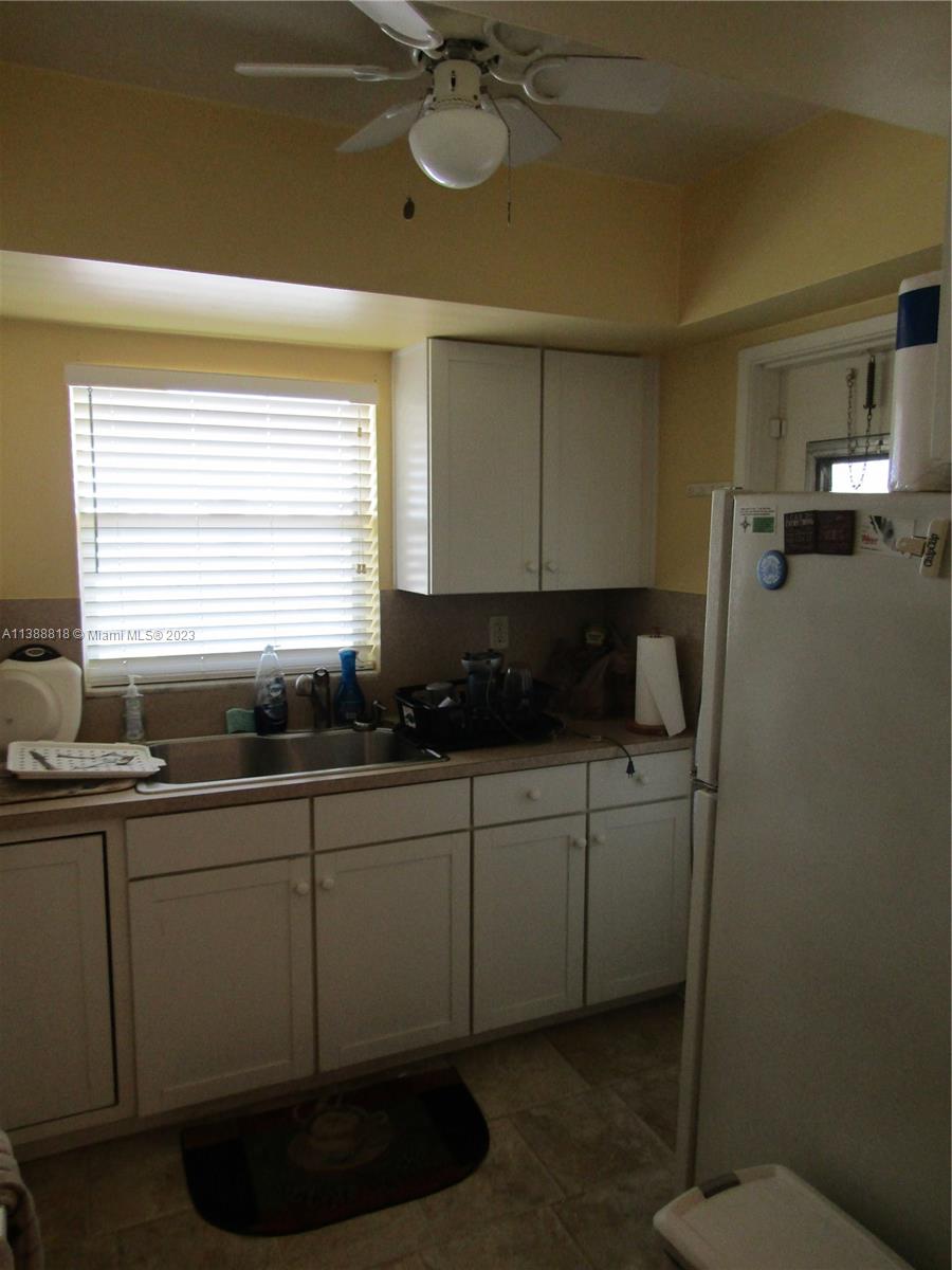 651 Pine Drive, Unit 309 Pompano Beach, FL 33060 - Photo 13 of 38 a kitchen with a sink and cabinets