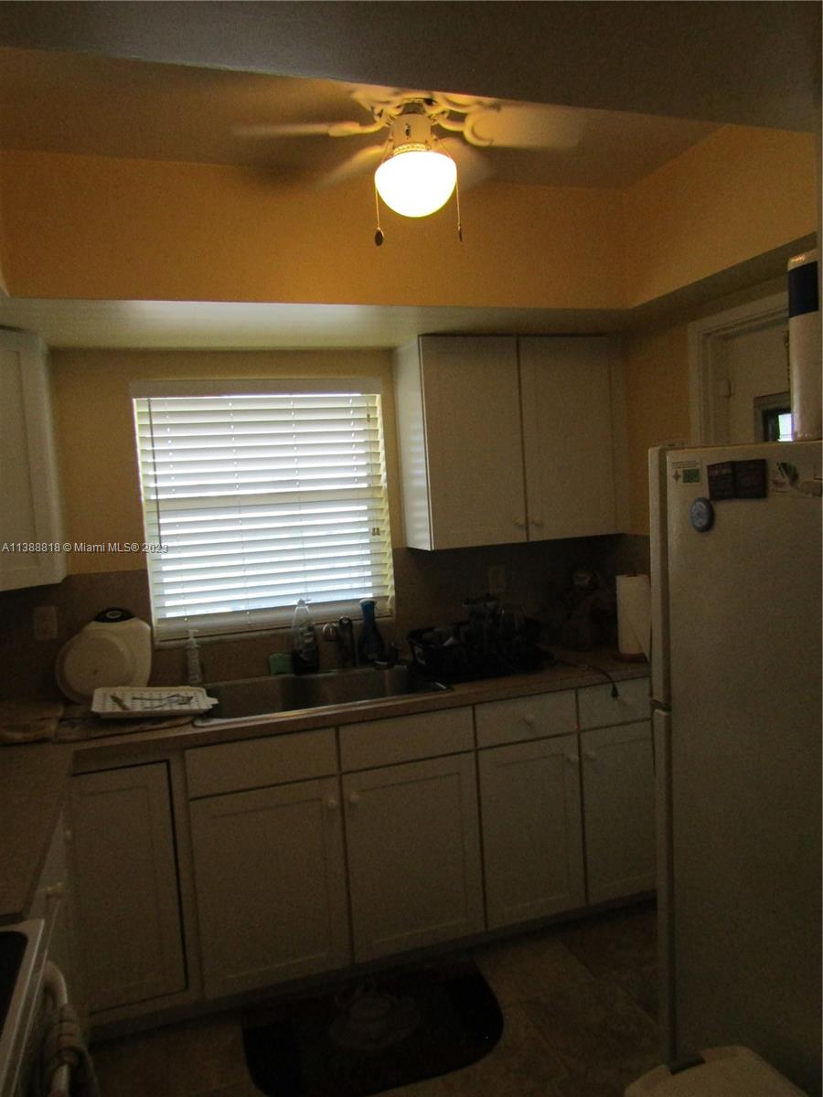 651 Pine Drive, Unit 309 Pompano Beach, FL 33060 - Photo 14 of 38 a kitchen with a sink and cabinets