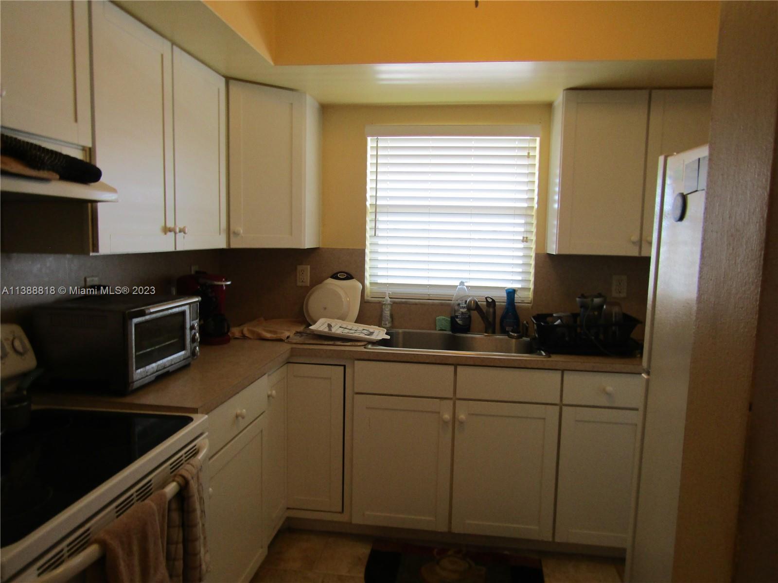 651 Pine Drive, Unit 309 Pompano Beach, FL 33060 - Photo 16 of 38 a kitchen with stainless steel appliances granite countertop a sink a stove and cabinets