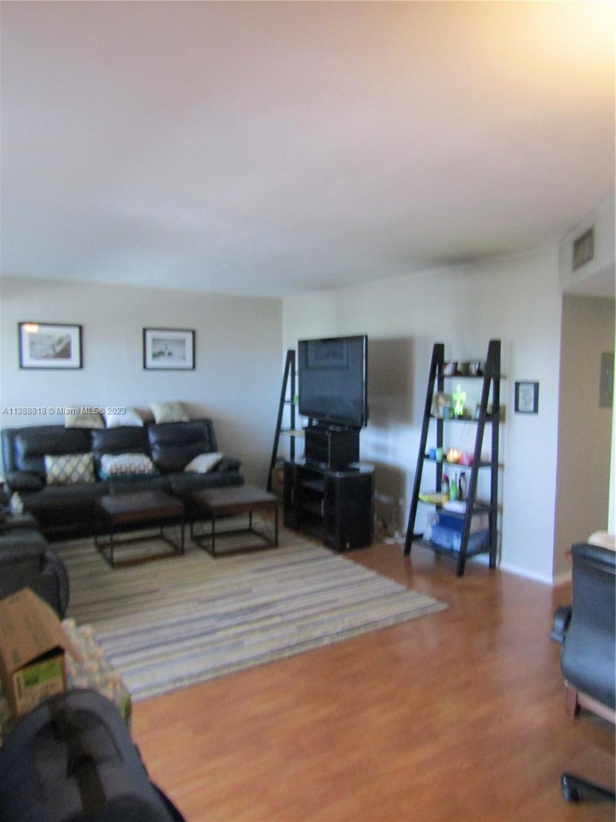651 Pine Drive, Unit 309 Pompano Beach, FL 33060 - Photo 18 of 38 a living room with furniture and a wooden floor