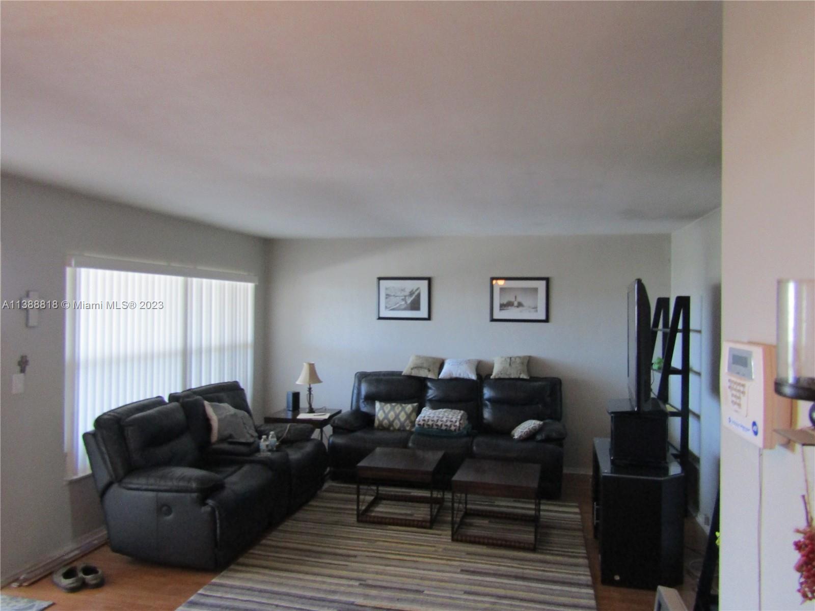 651 Pine Drive, Unit 309 Pompano Beach, FL 33060 - Photo 19 of 38 a living room with furniture a refrigerator and a window
