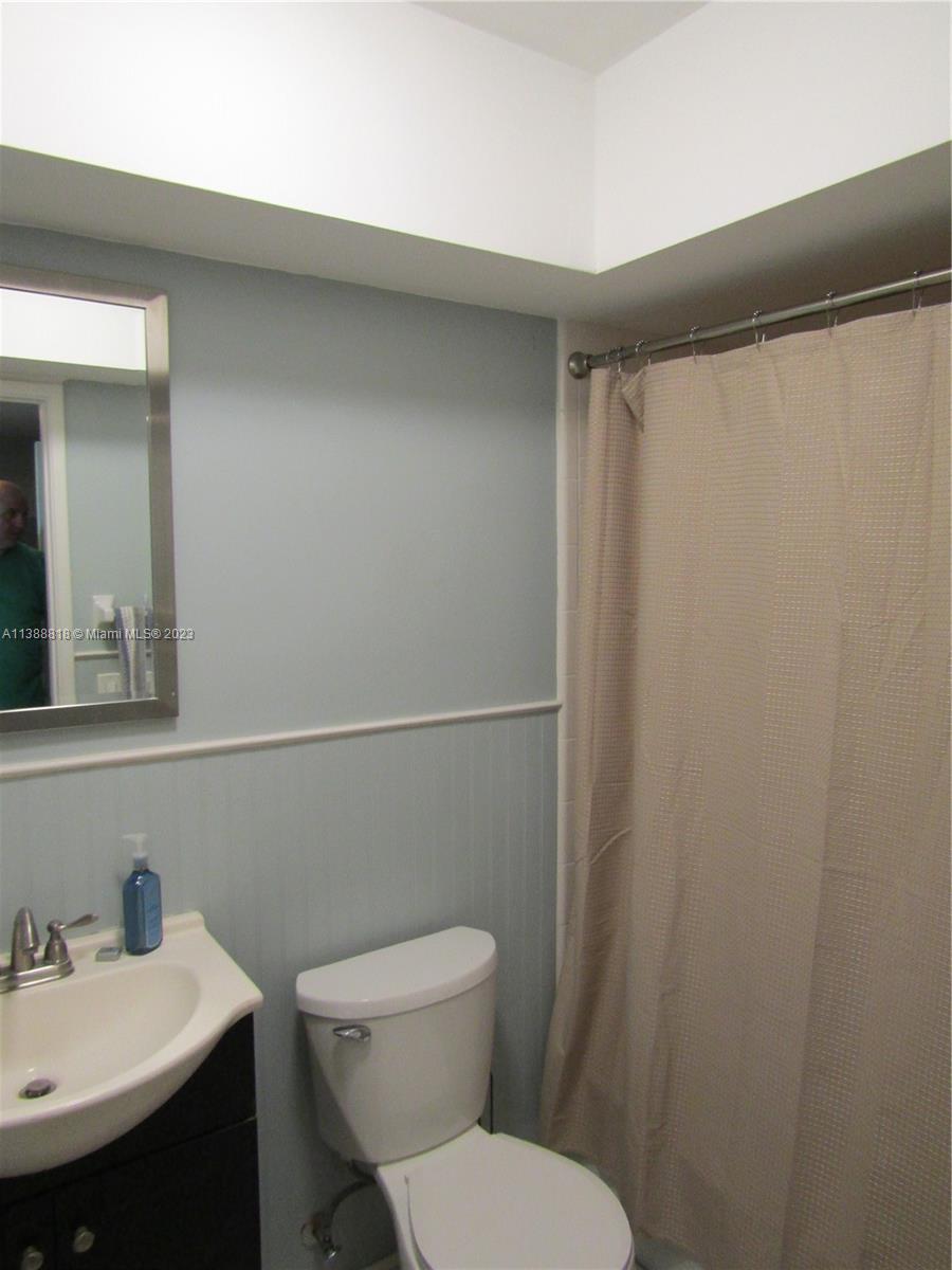 651 Pine Drive, Unit 309 Pompano Beach, FL 33060 - Photo 20 of 38 a white toilet sitting next to a bathroom sink