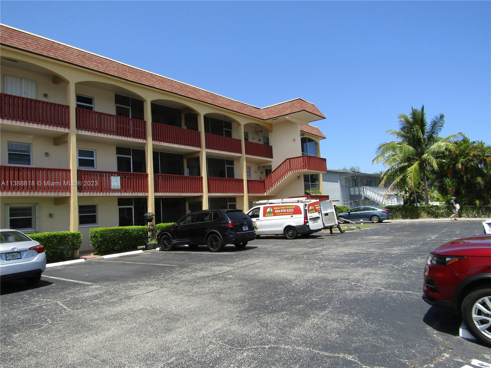 651 Pine Drive, Unit 309 Pompano Beach, FL 33060 - Photo 2 of 38 a car parked in front of a house