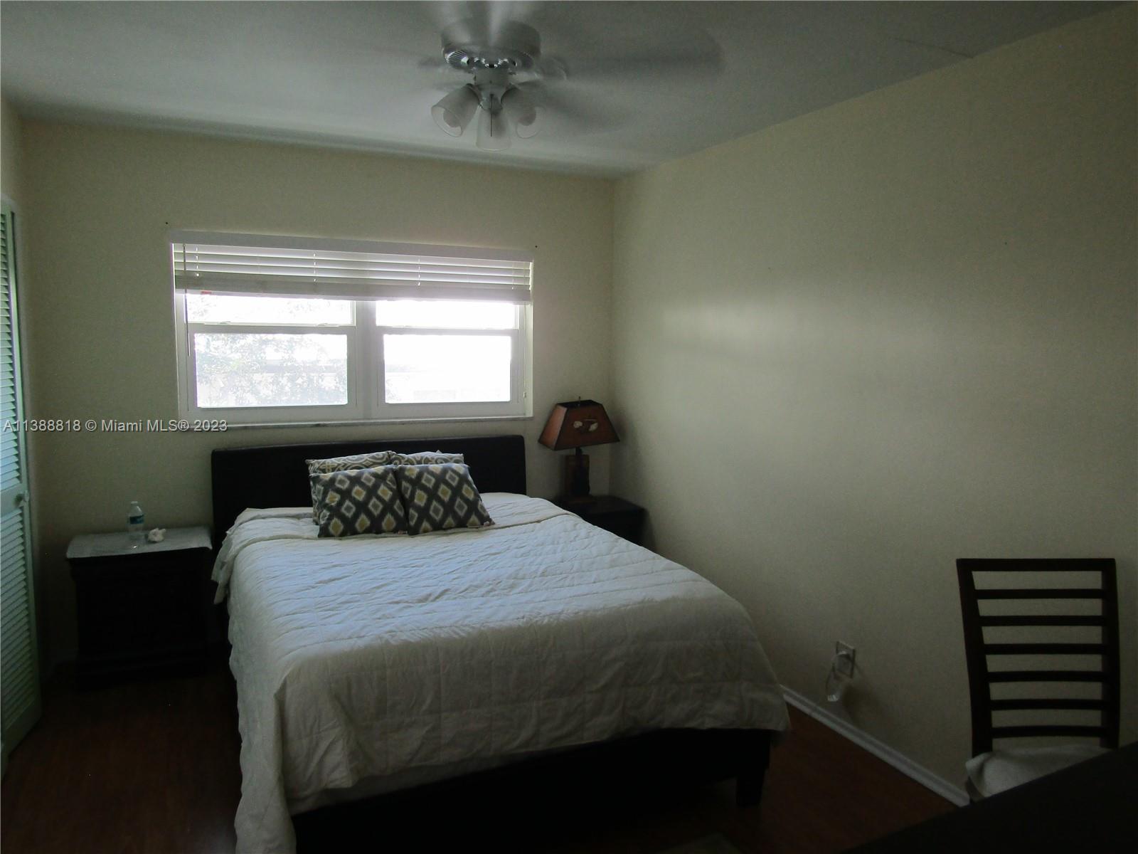 651 Pine Drive, Unit 309 Pompano Beach, FL 33060 - Photo 23 of 38 a bedroom with a bed and a window