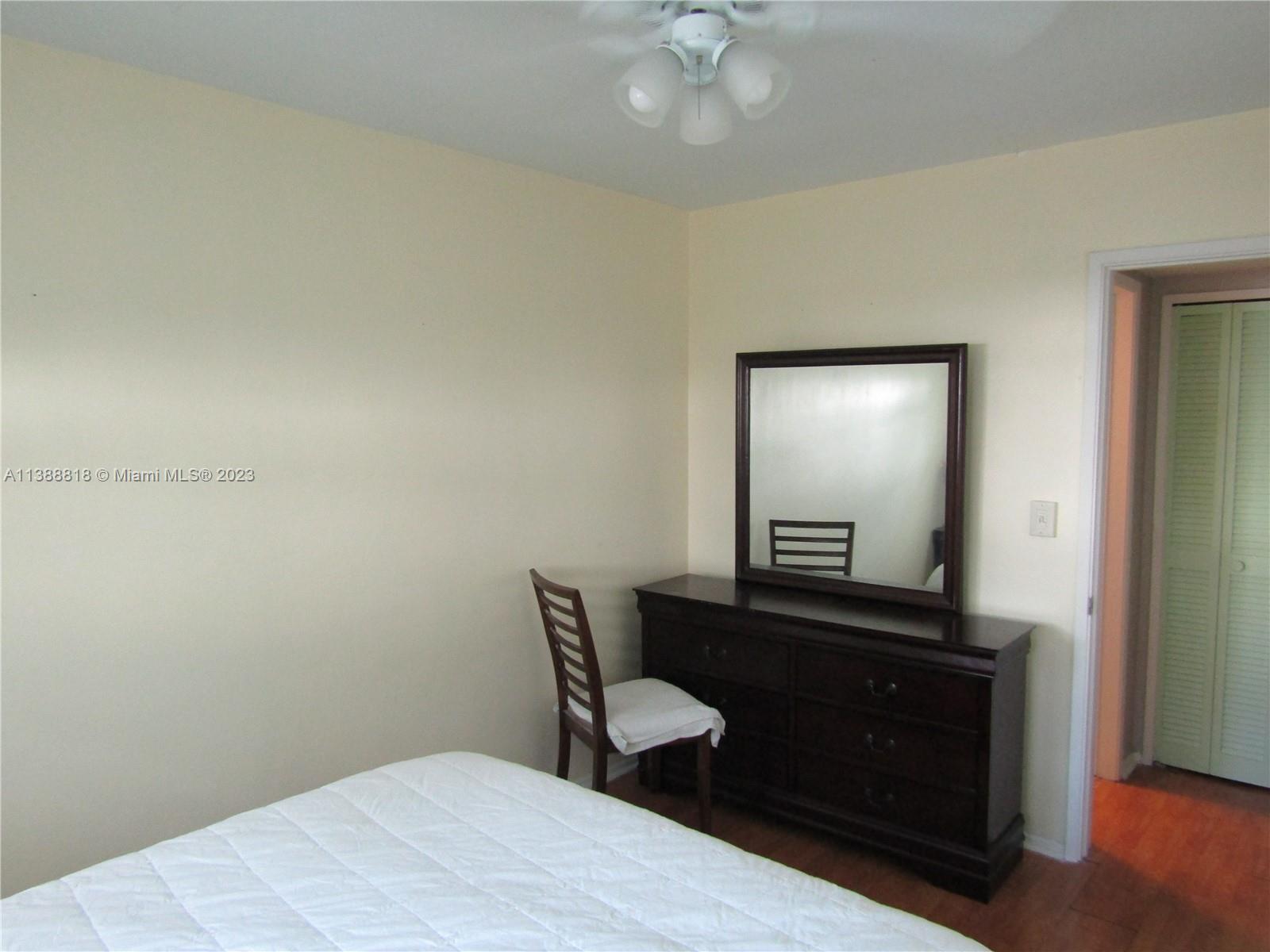651 Pine Drive, Unit 309 Pompano Beach, FL 33060 - Photo 25 of 38 a bedroom with a bed and a mirror