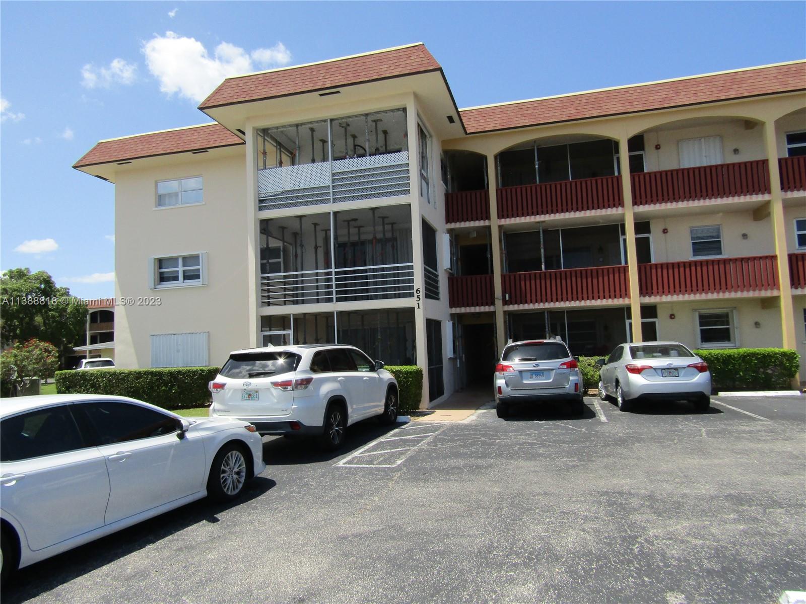 651 Pine Drive, Unit 309 Pompano Beach, FL 33060 - Photo 3 of 38 a car parked in front of a building