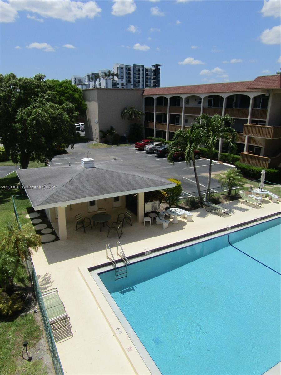 651 Pine Drive, Unit 309 Pompano Beach, FL 33060 - Photo 34 of 38 a view of a house with pool and chairs