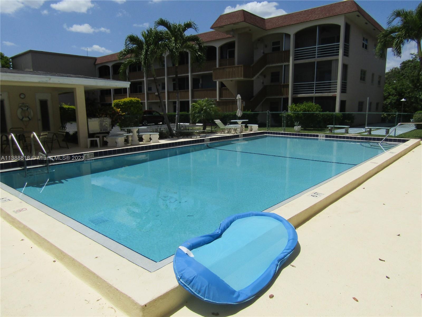 651 Pine Drive, Unit 309 Pompano Beach, FL 33060 - Photo 35 of 38 a view of a swimming pool with chairs in patio
