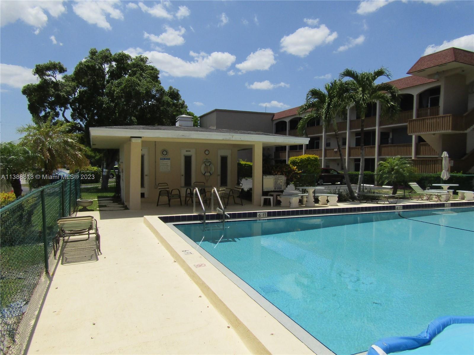 651 Pine Drive, Unit 309 Pompano Beach, FL 33060 - Photo 36 of 38 a view of a swimming pool with outdoor seating