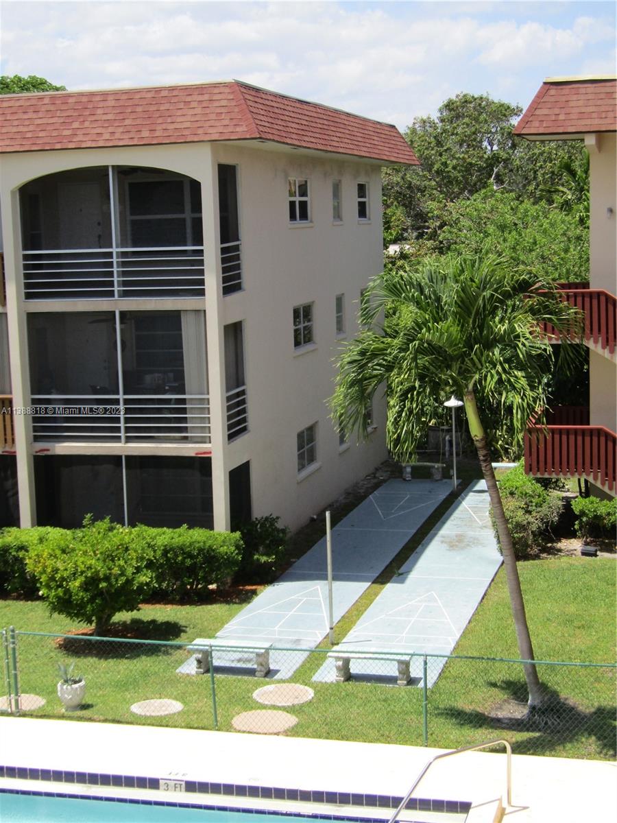 651 Pine Drive, Unit 309 Pompano Beach, FL 33060 - Photo 37 of 38 a front view of a house with a yard