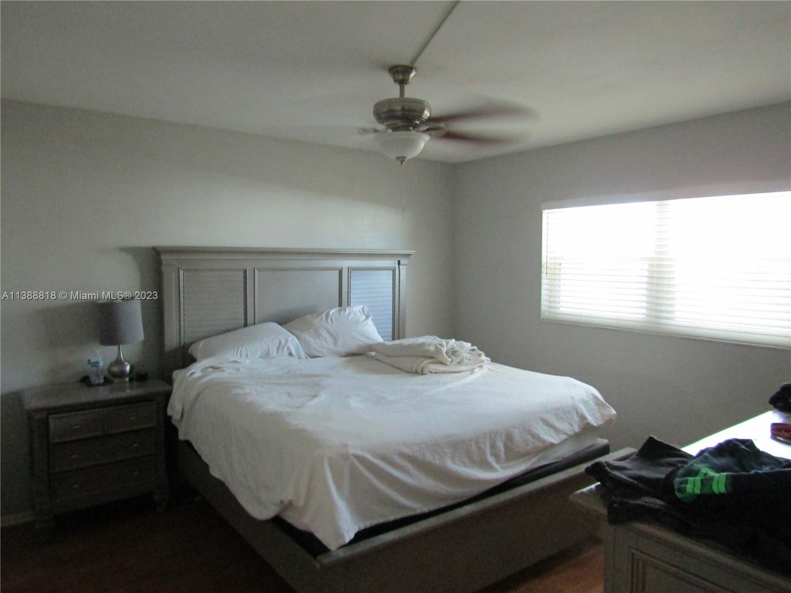 651 Pine Drive, Unit 309 Pompano Beach, FL 33060 - Photo 4 of 38 a bedroom with a bed and window