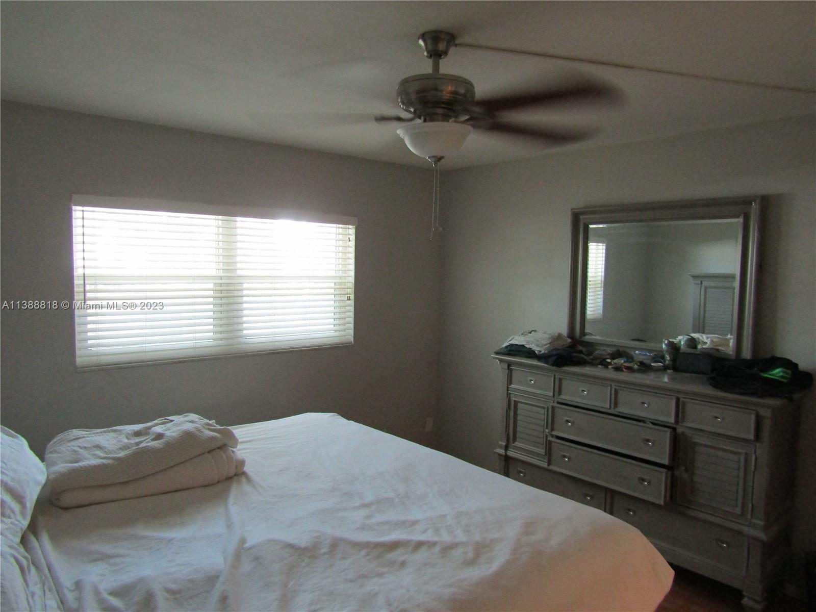651 Pine Drive, Unit 309 Pompano Beach, FL 33060 - Photo 5 of 38 a bedroom with a bed and a dresser
