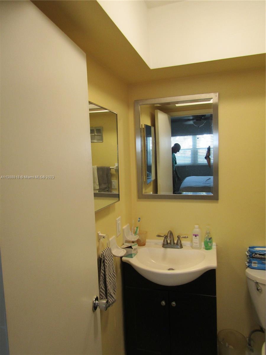 651 Pine Drive, Unit 309 Pompano Beach, FL 33060 - Photo 7 of 38 a bathroom with a sink and a mirror