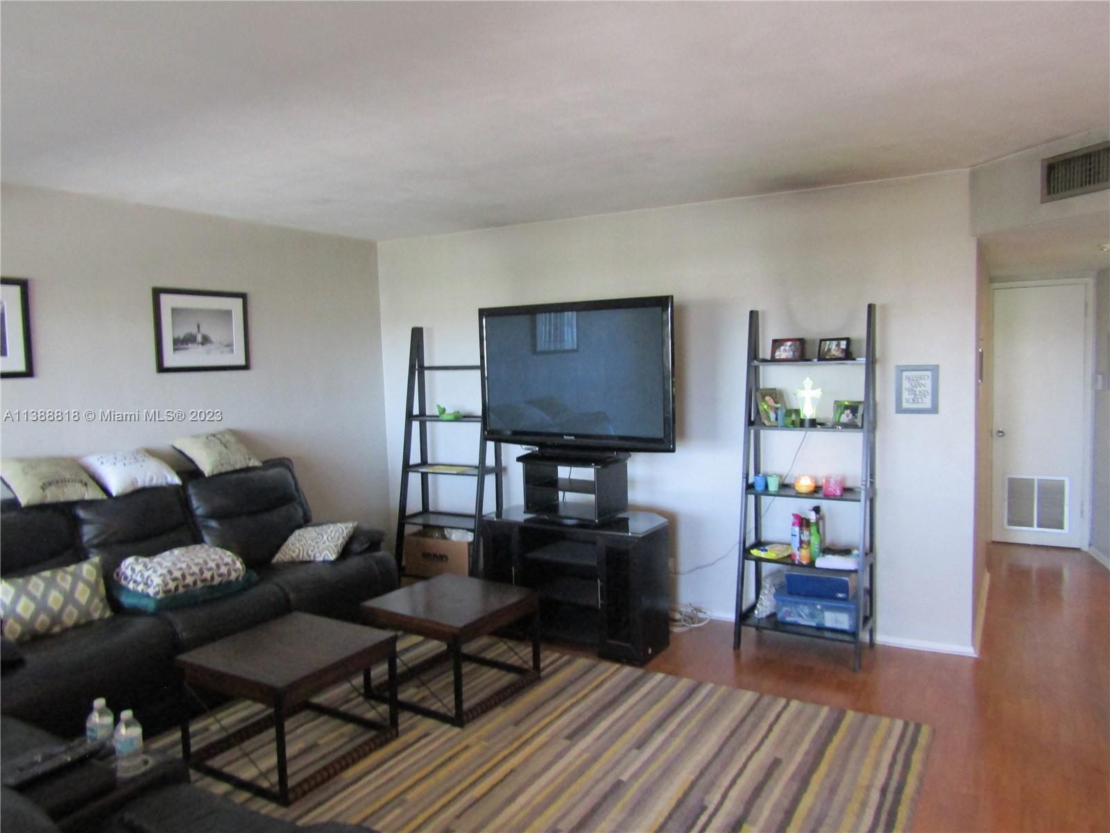 651 Pine Drive, Unit 309 Pompano Beach, FL 33060 - Photo 10 of 38 a living room with furniture and a wooden floor