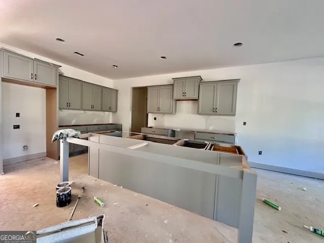 a kitchen with a sink stove and cabinets