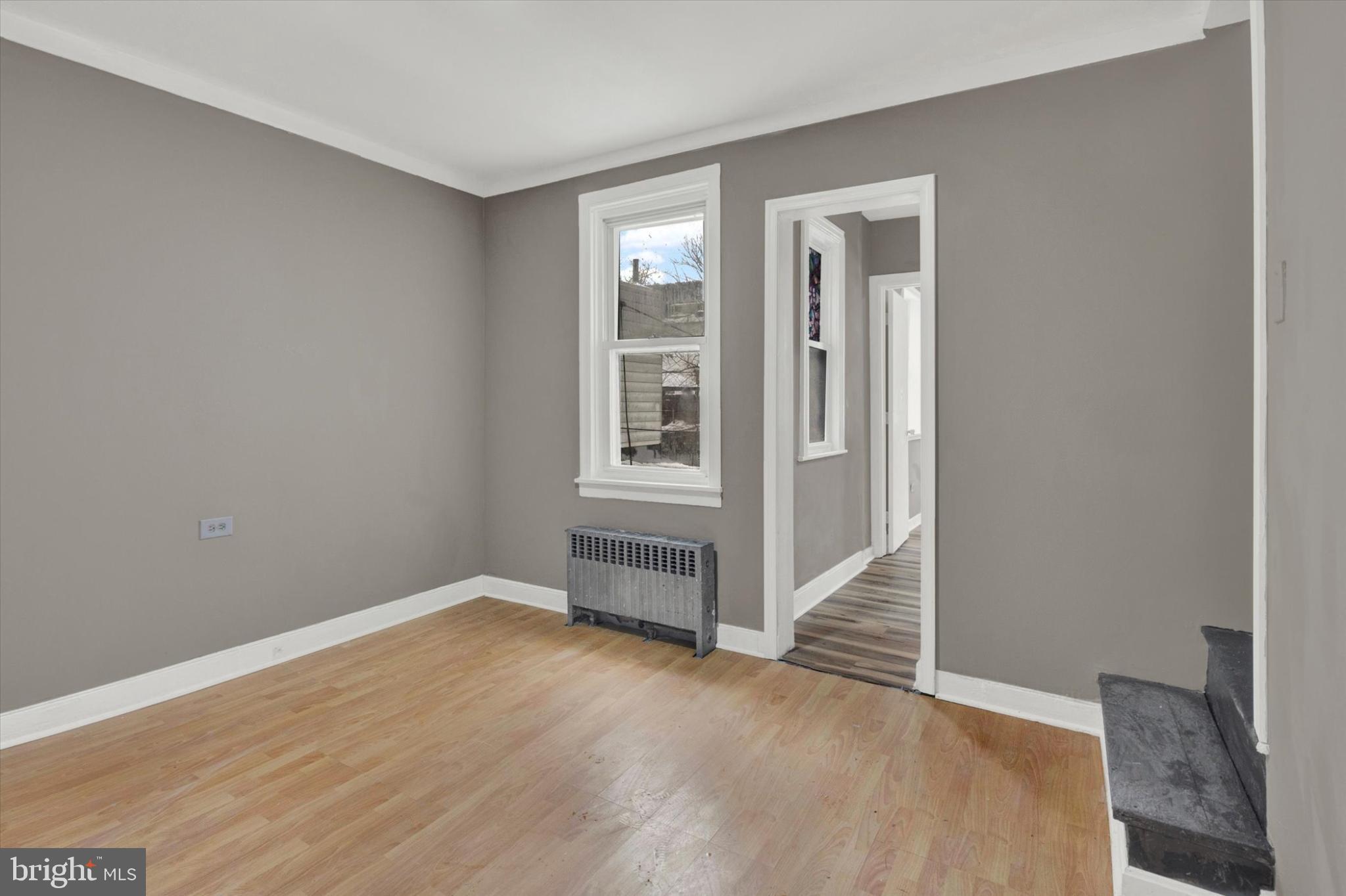 131 Mulberry Street Reading, PA 19601 - Photo 11 of 24 an empty room with wooden floor and windows