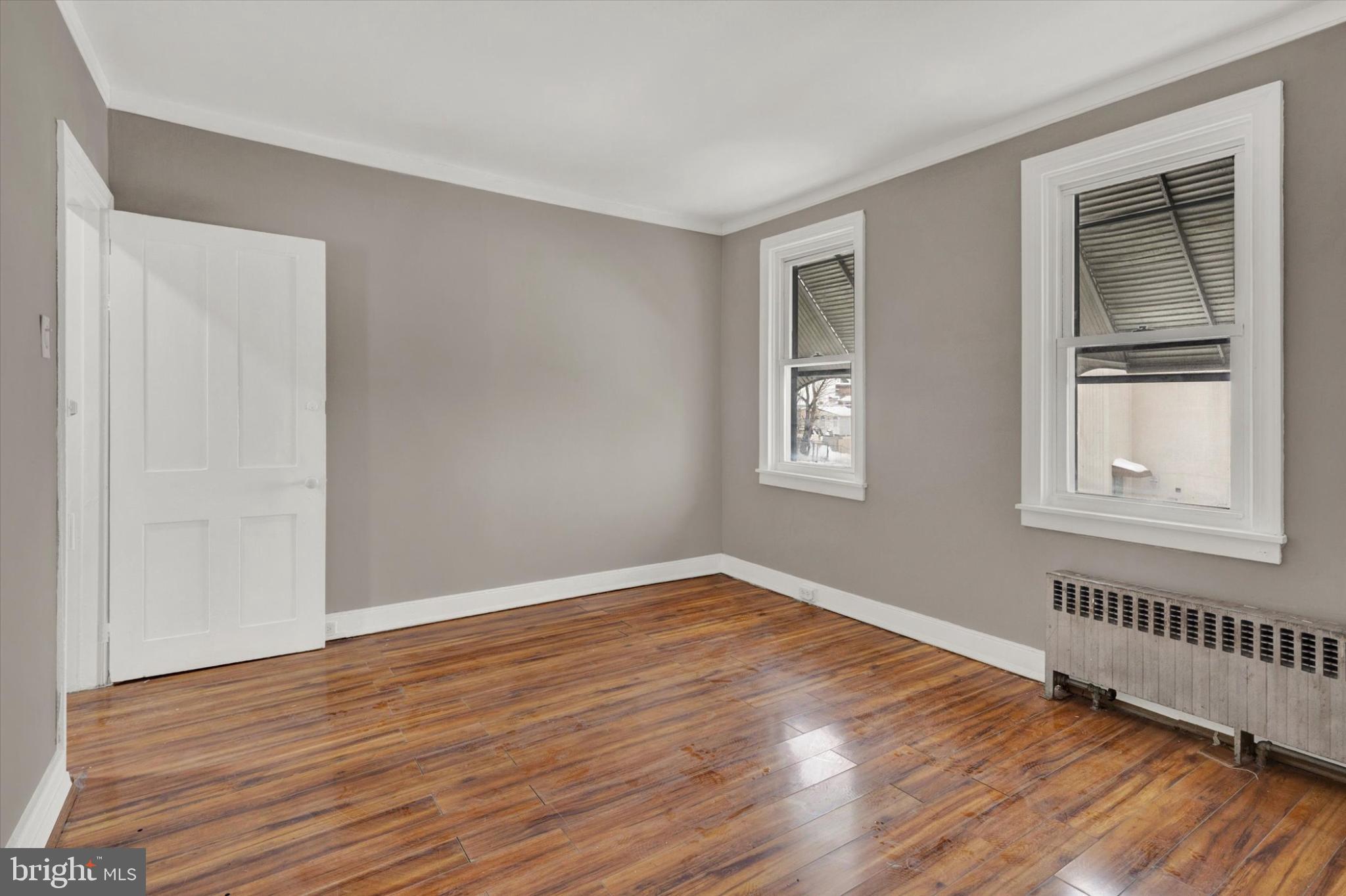 131 Mulberry Street Reading, PA 19601 - Photo 14 of 24 a view of an empty room with wooden floor and a window