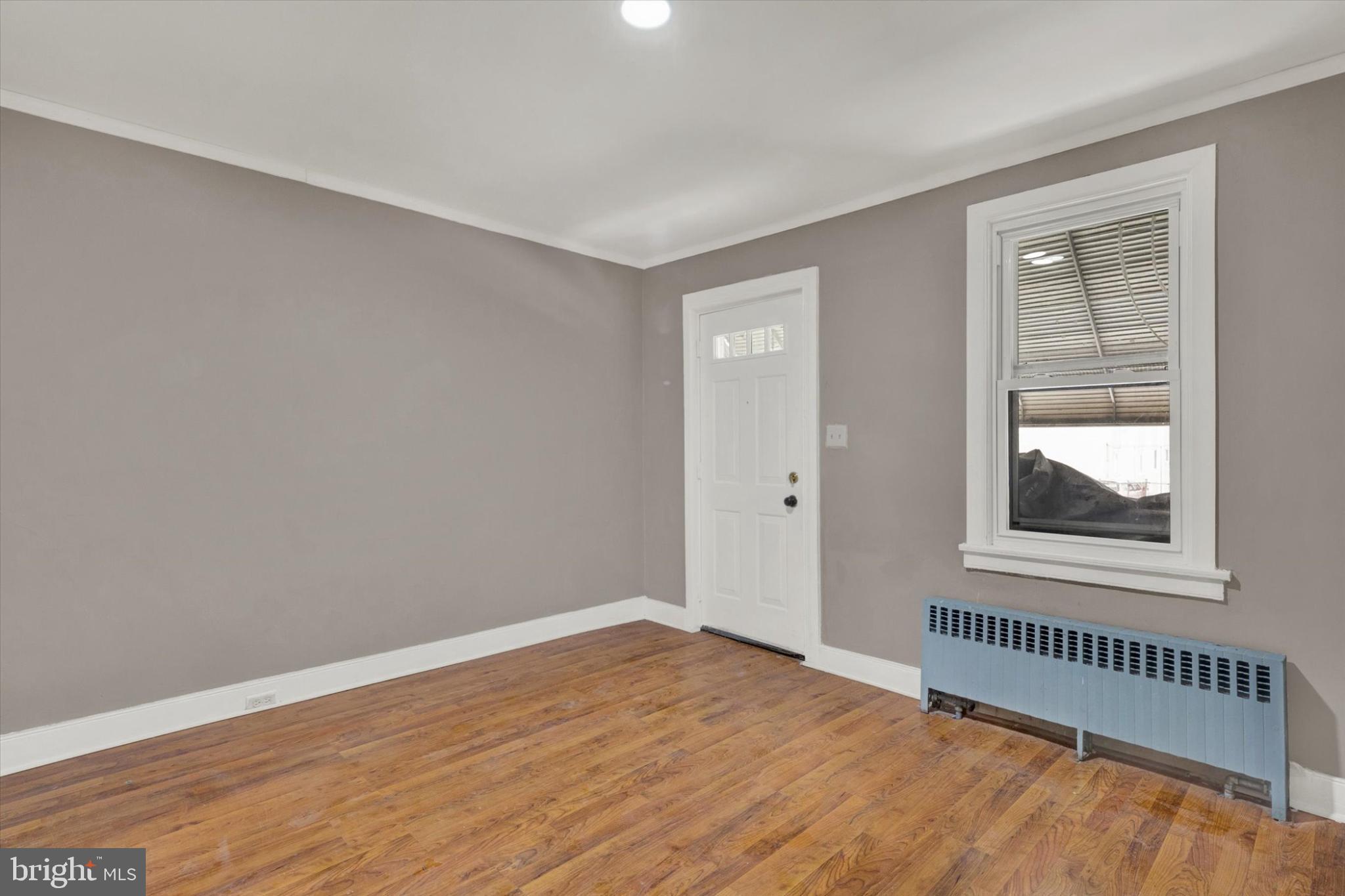 131 Mulberry Street Reading, PA 19601 - Photo 2 of 24 a view of an empty room with wooden floor and a window