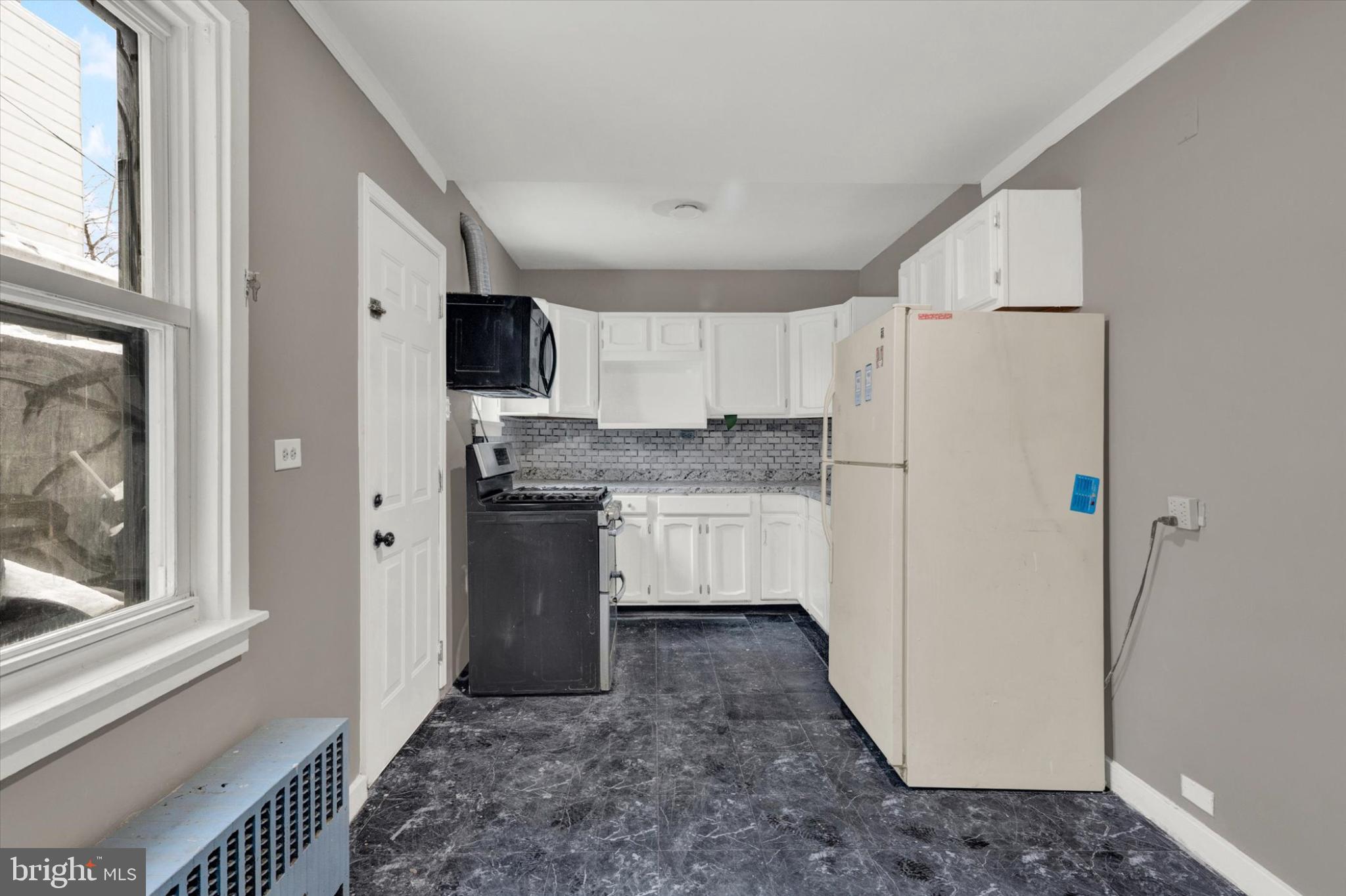 131 Mulberry Street Reading, PA 19601 - Photo 7 of 24 a kitchen with a refrigerator sink and cabinets