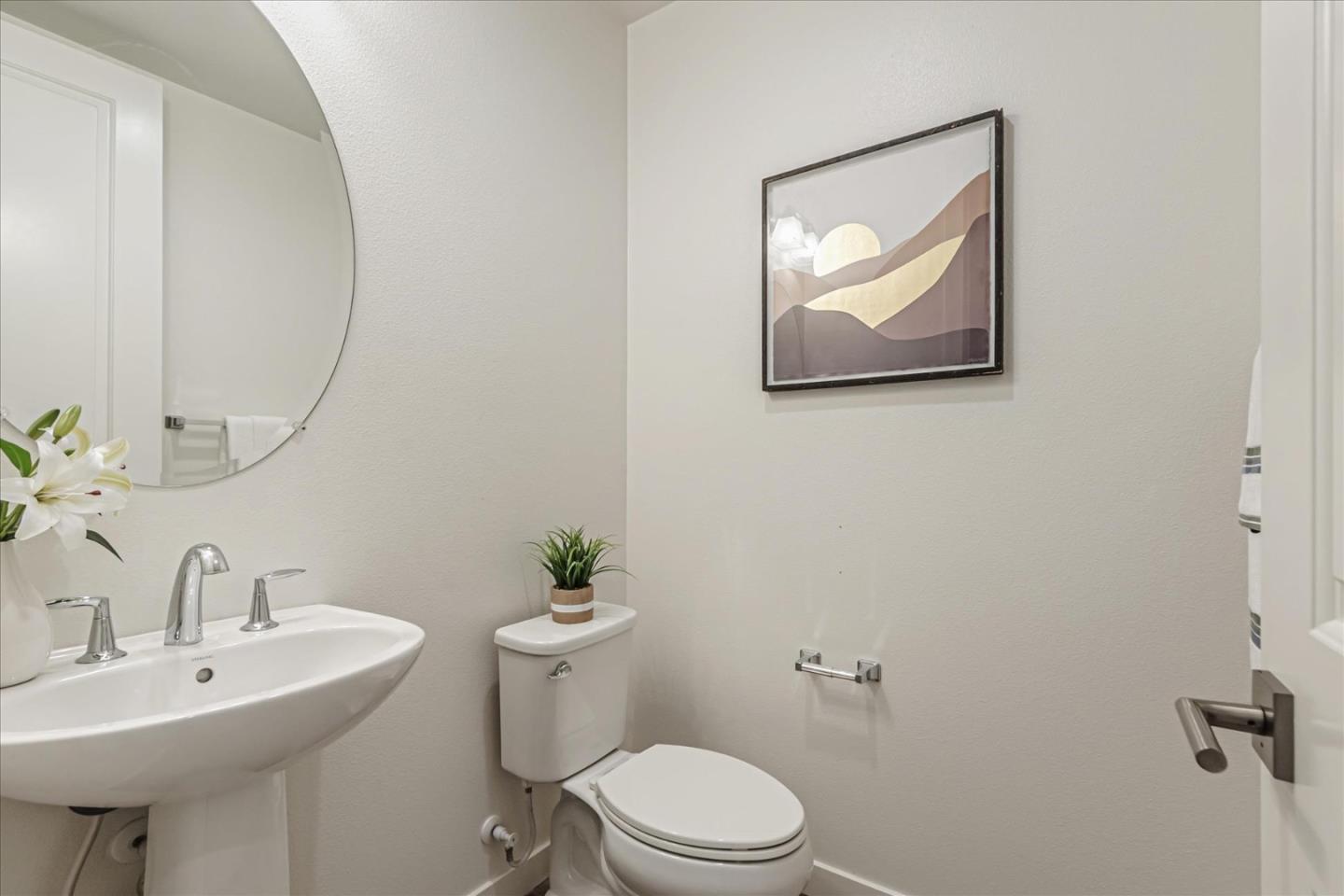 1907 Joshua Tree Circle Milpitas, CA 95035 - Photo 23 of 37 a bathroom with a toilet a sink and mirror