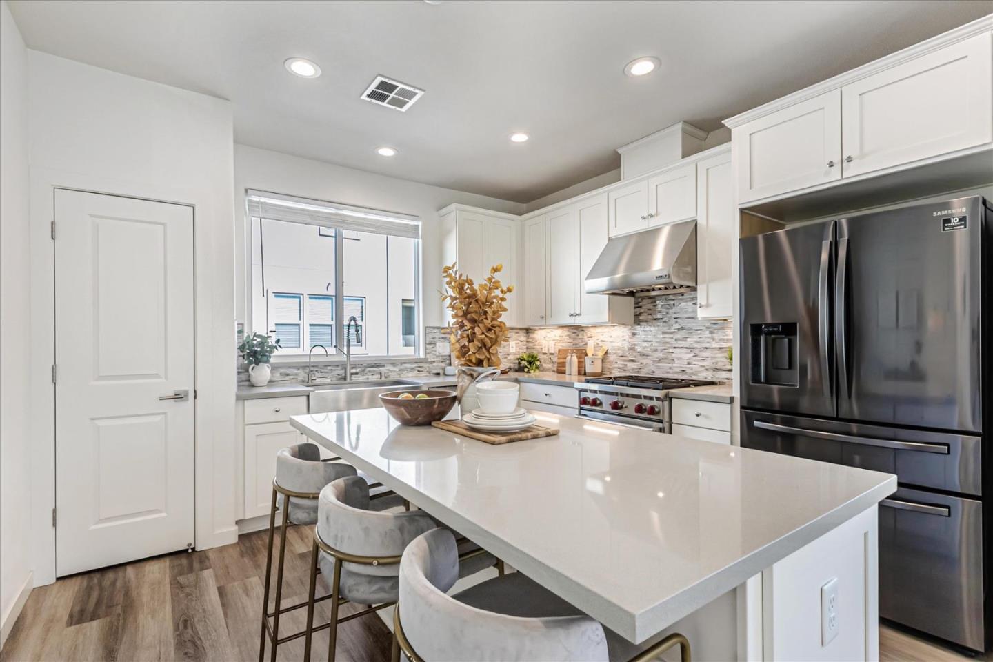 1907 Joshua Tree Circle Milpitas, CA 95035 - Photo 6 of 37 a kitchen with kitchen island a stove a sink and a refrigerator