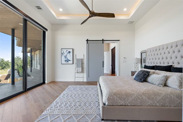 a bedroom with a large bed and a large mirror