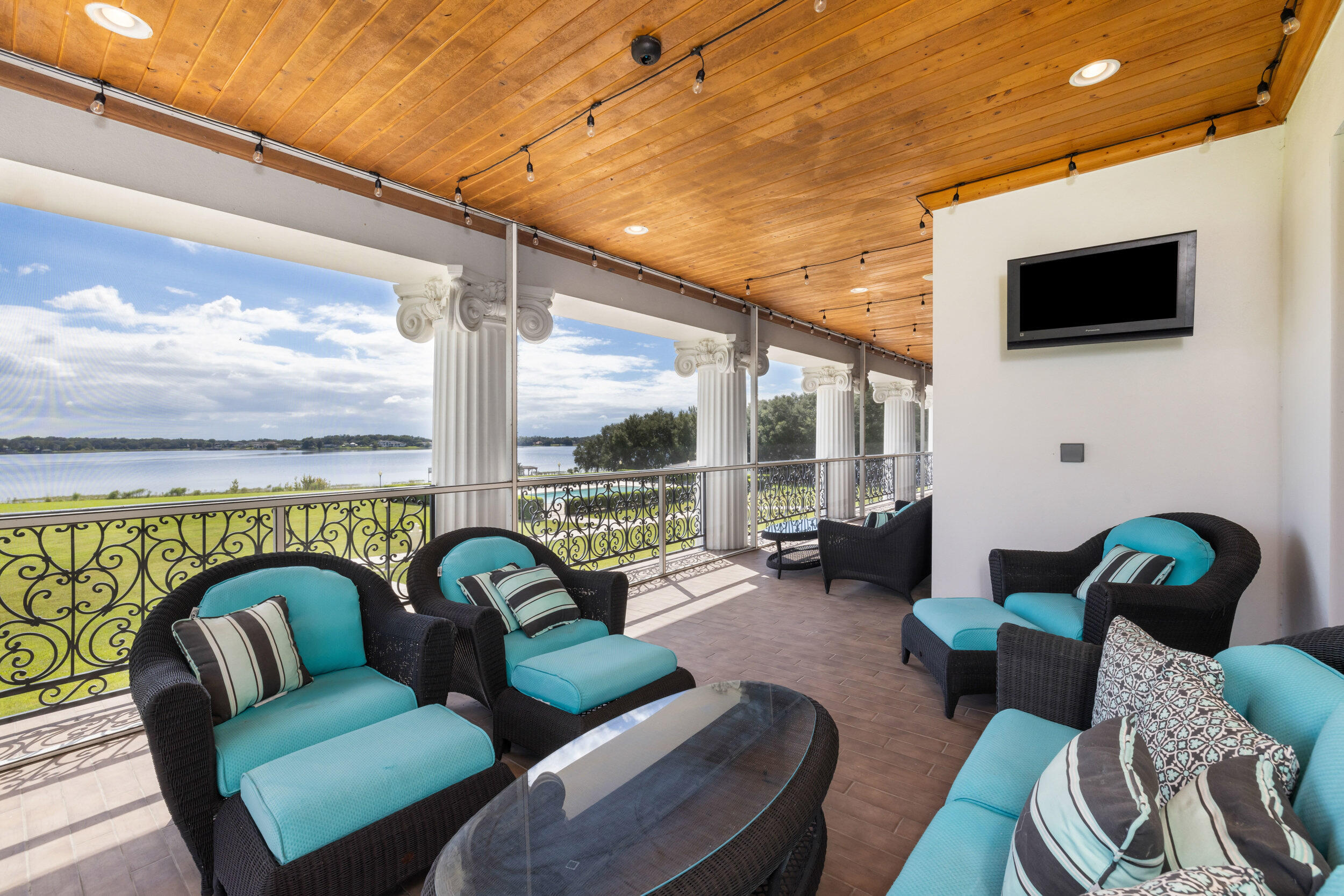 9508 Windy Ridge Road Windermere, FL 34786 - Photo 28 of 49 a living room with furniture a floor to ceiling window and a flat screen tv