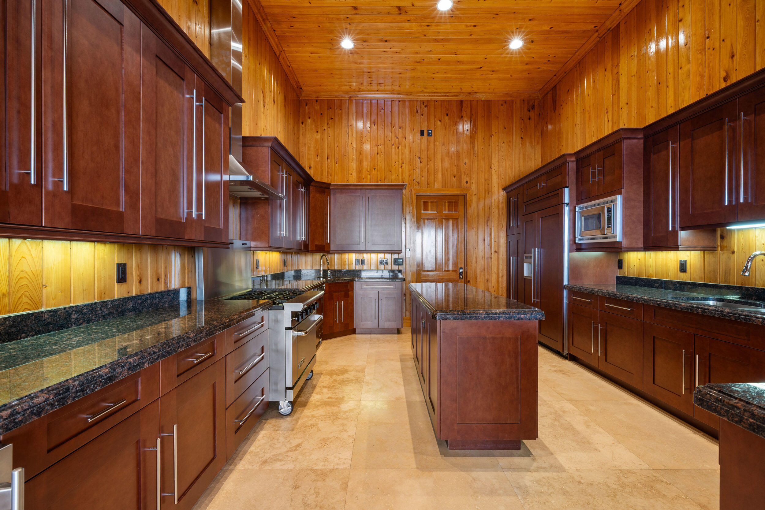 9508 Windy Ridge Road Windermere, FL 34786 - Photo 42 of 49 a kitchen with stainless steel appliances granite countertop wooden cabinets a stove top oven a sink and dishwasher