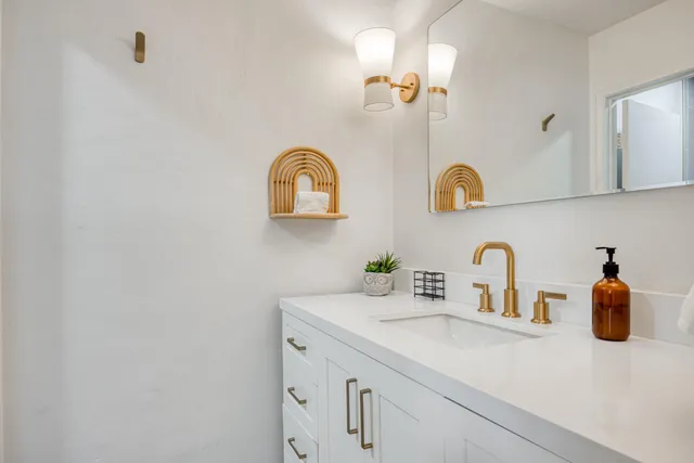 a bathroom with a sink and a mirror