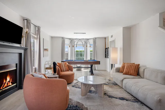 a living room with furniture fireplace and flat screen tv