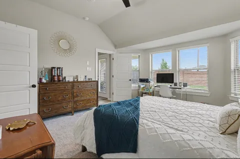 a large bedroom with a bed and furniture